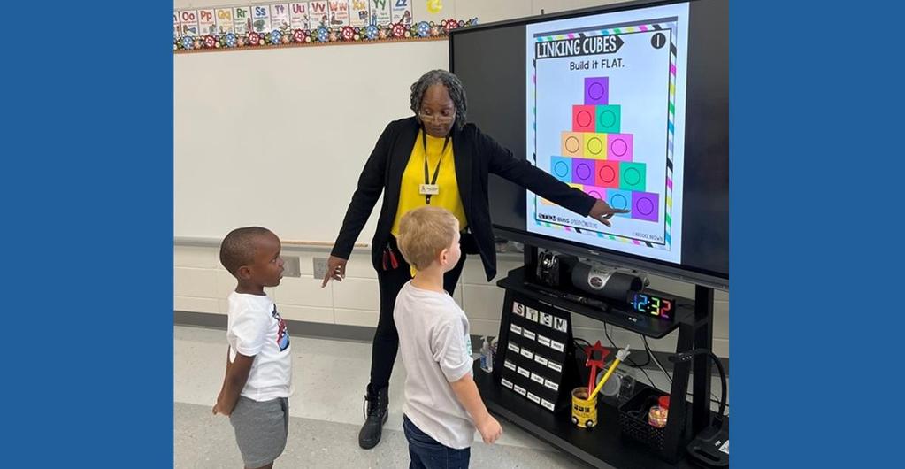Teacher helping young students make connections with a smart board