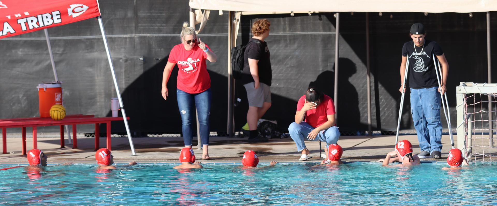 boys water polo players in action against hoover