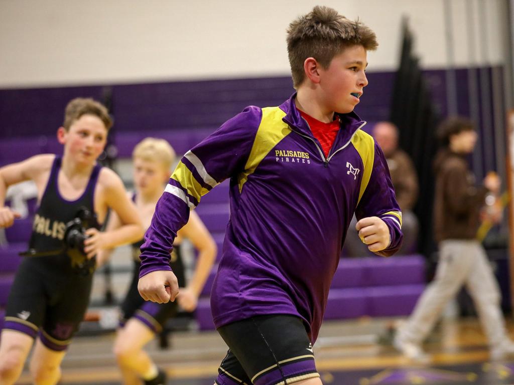 A basketball player running on the indoor court.