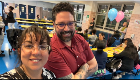 Principal and assistant principal smiling at the camera