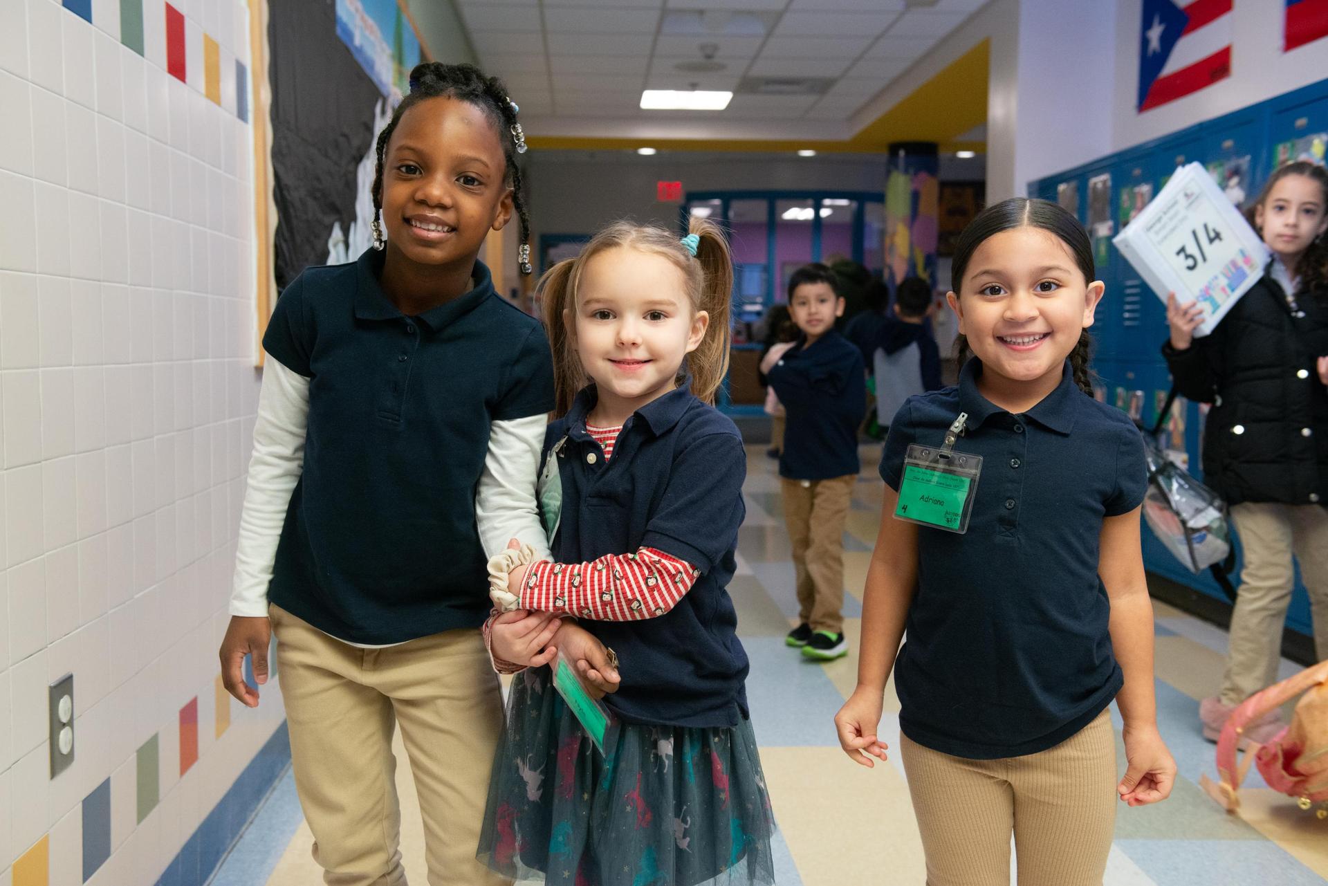 three students in school uniforms