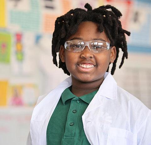 HSA Davenport student writing at a desk in a classroom setting