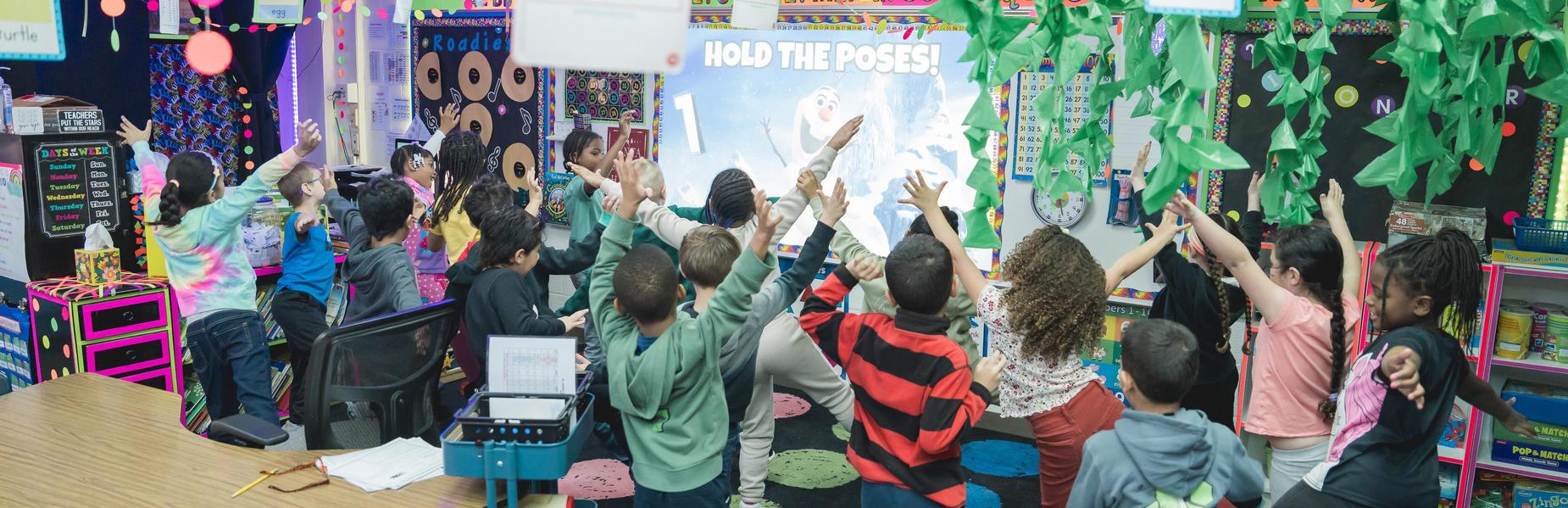 Students joyfully participate in a colorful classroom activity.
