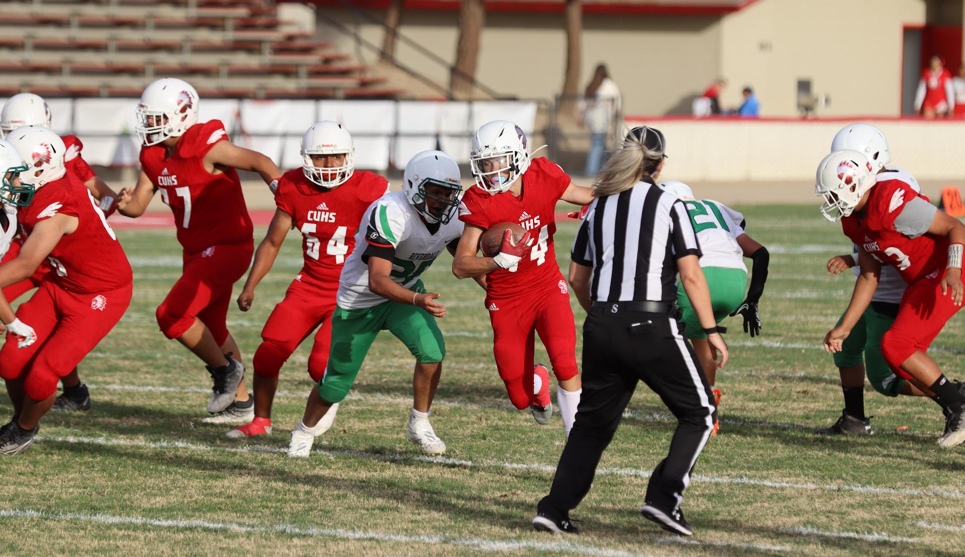  junior varsity football players in action against riverdale
