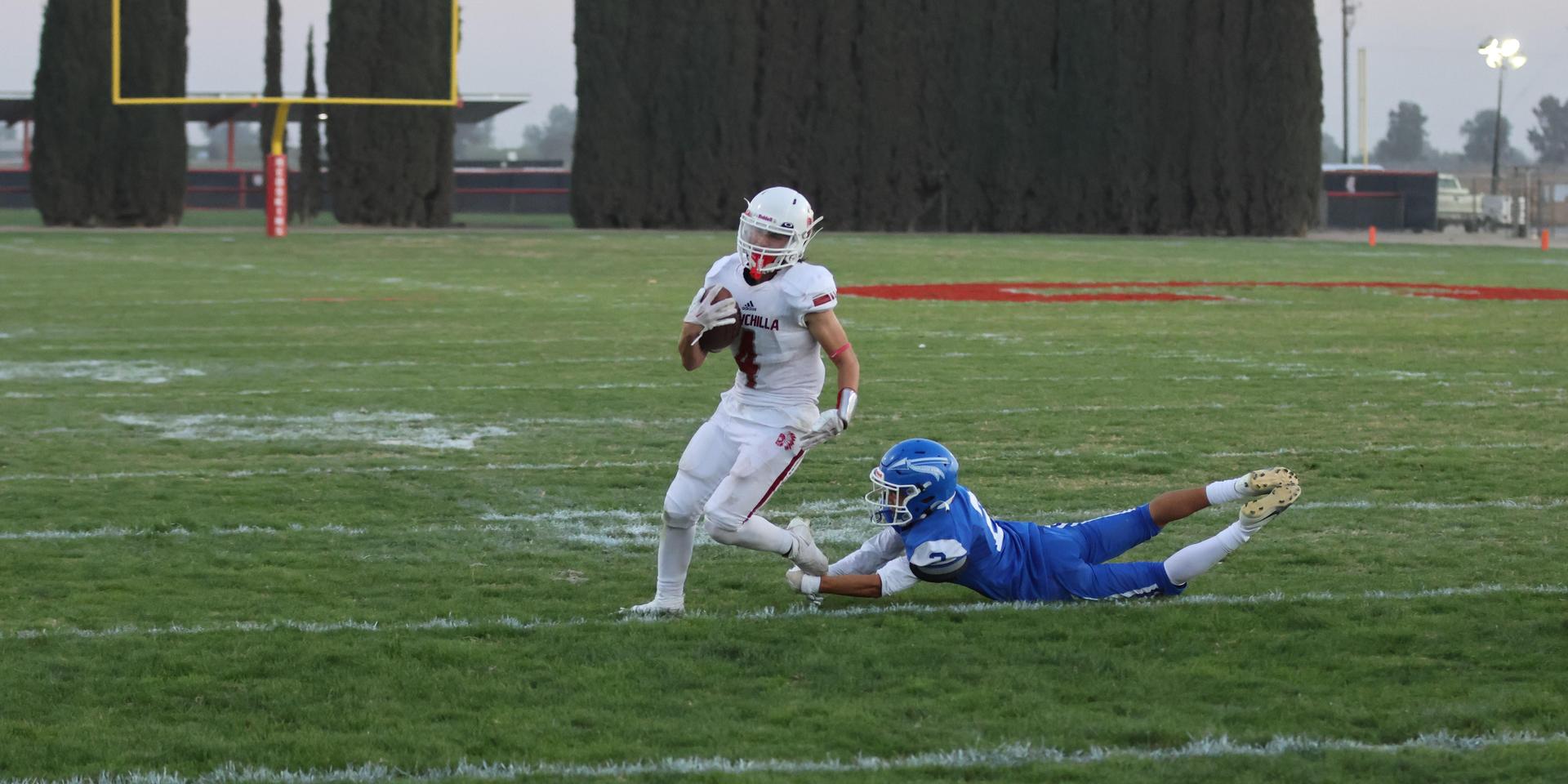 Junior Varsity football players in action against Caruthers