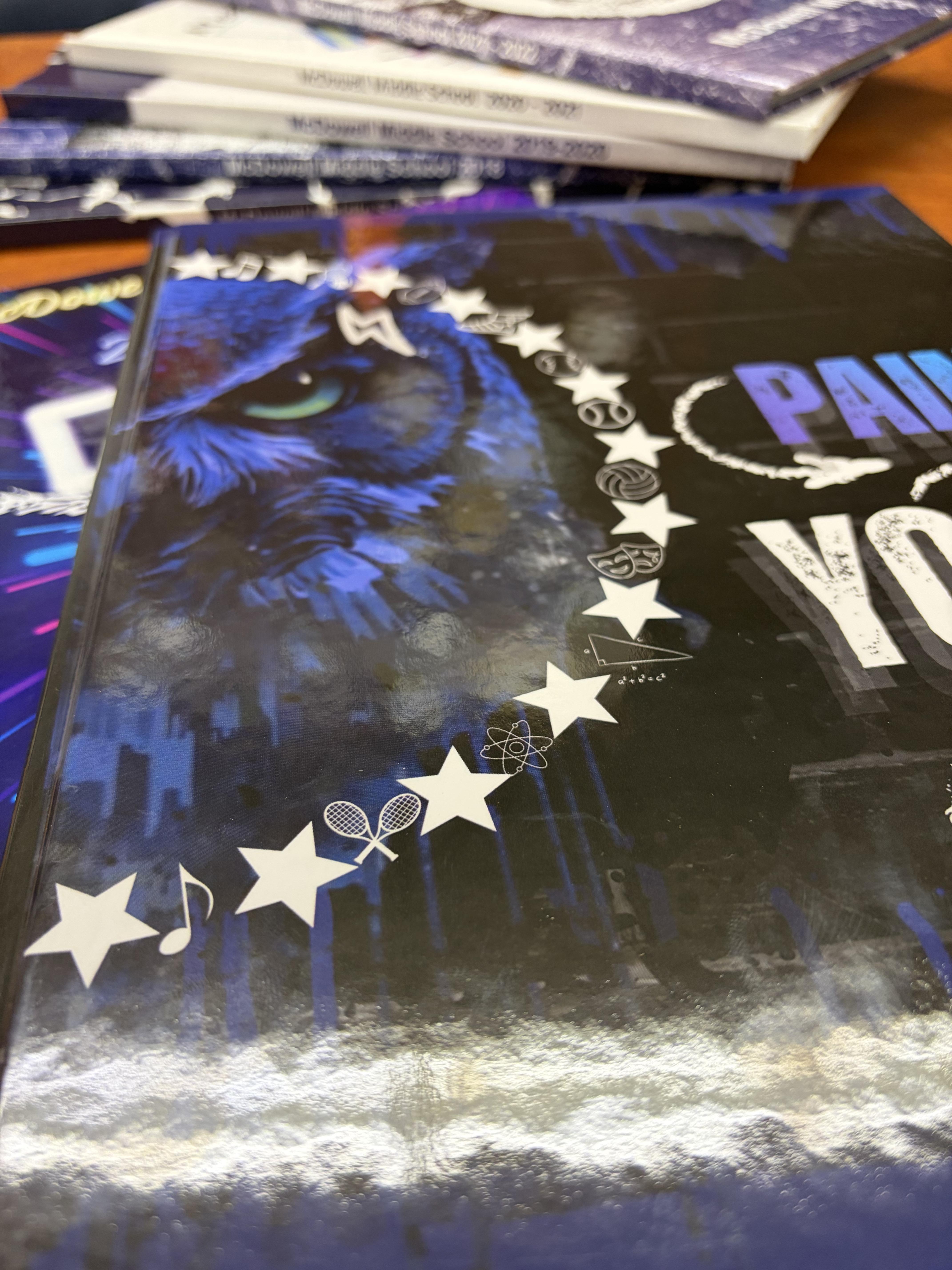 Stacks of historical McDowell Middle School yearbooks.