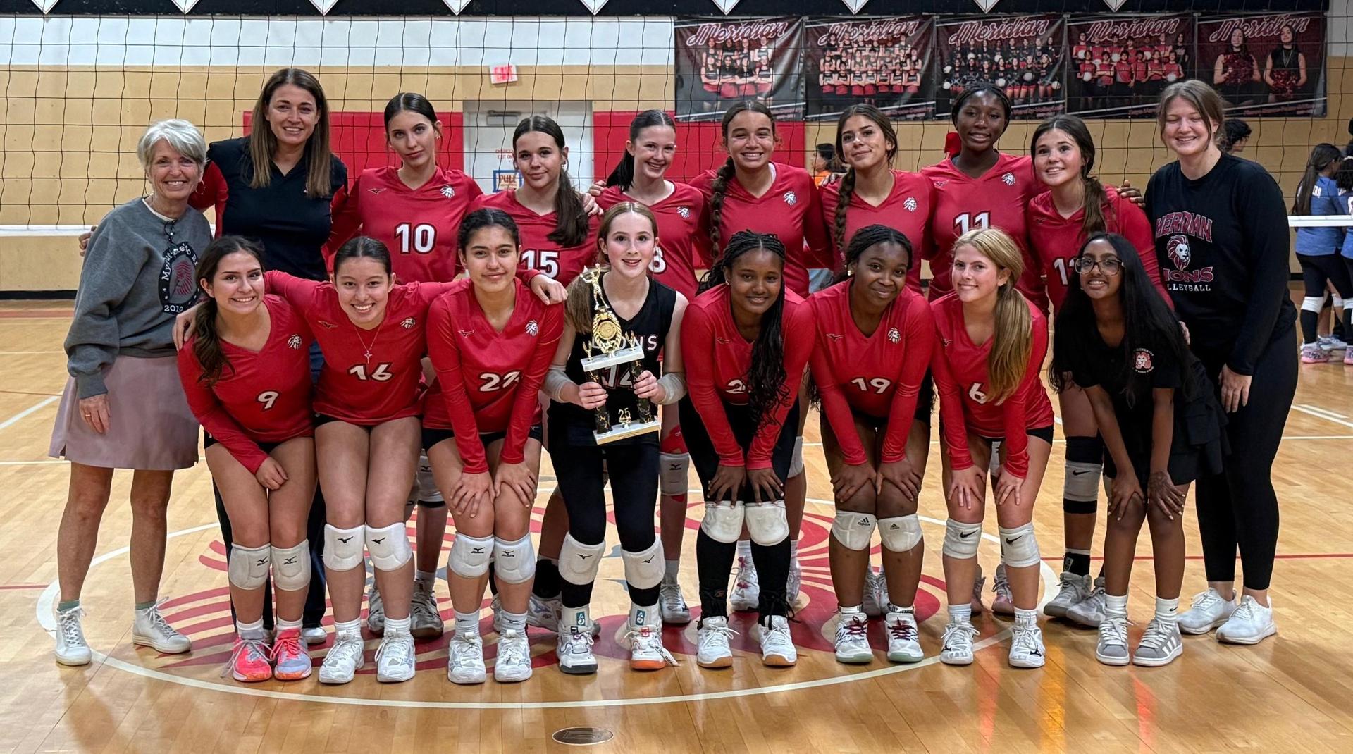 Girls Varsity stands in the middle of the gym with CEO Karalei Nunn and coaches