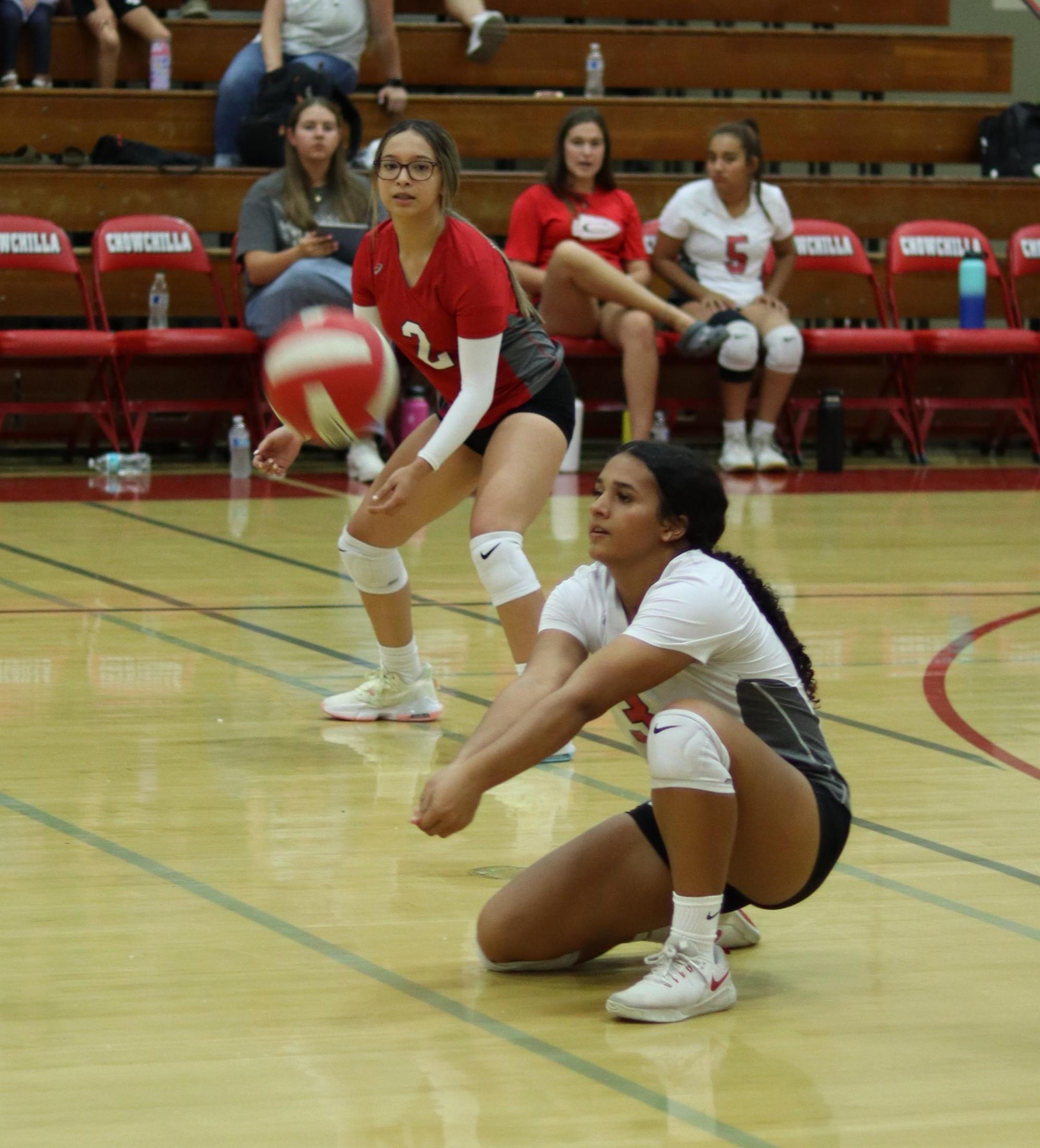 varsity girls playing volleyball against Firebaugh