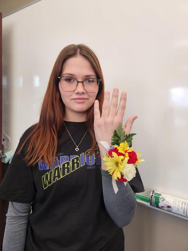 Annaleah Alloway holding her hand showing off the corsage she made.
