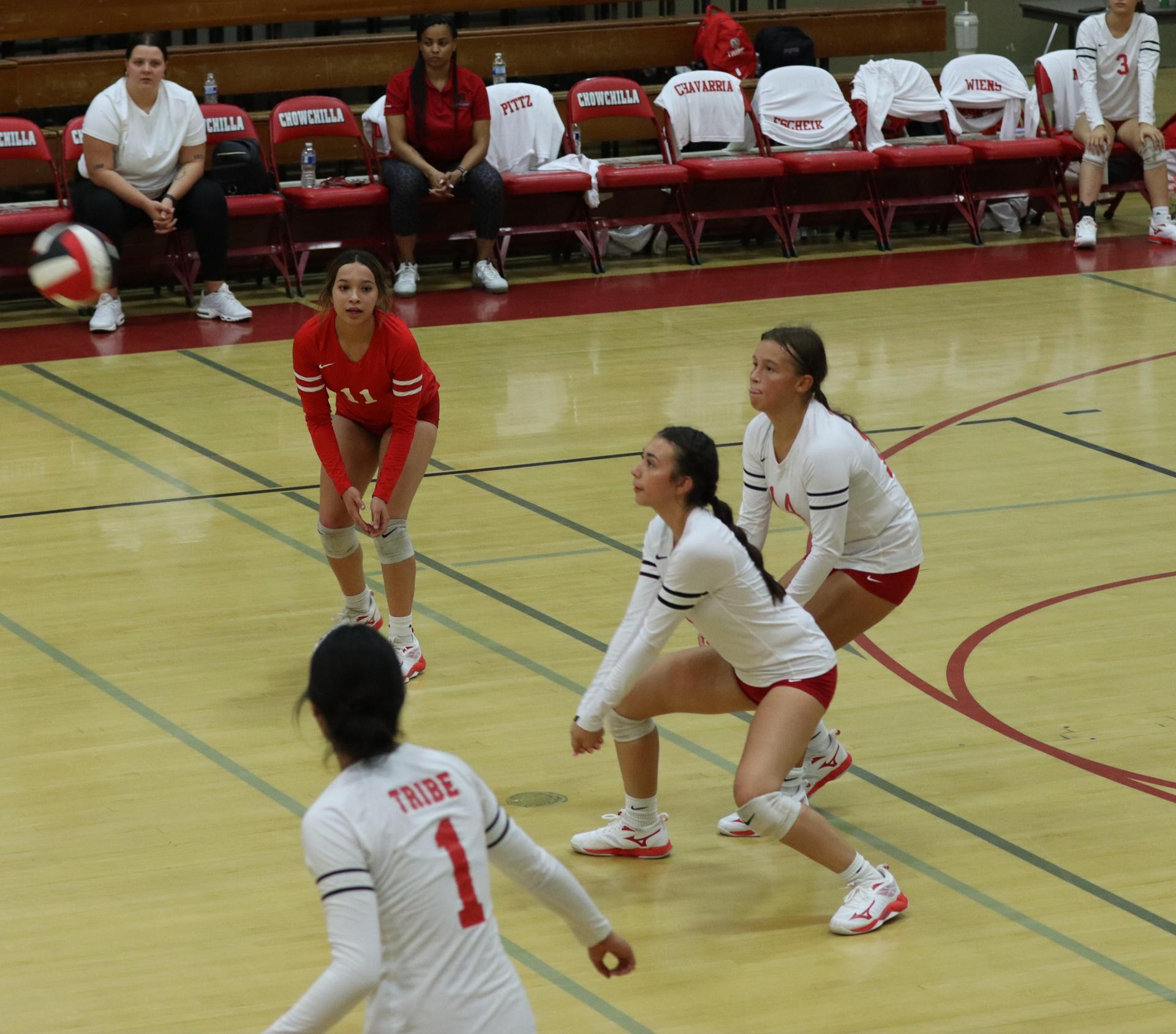 varsity volleyball players in action against liberty