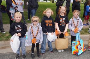 A group of young students, dressed in TK colors, wait for the parade to start.