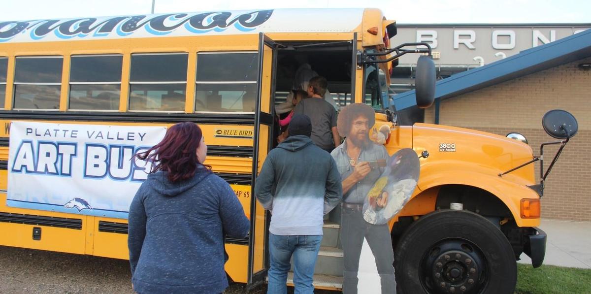 People walking onto Homecoming Art Bus