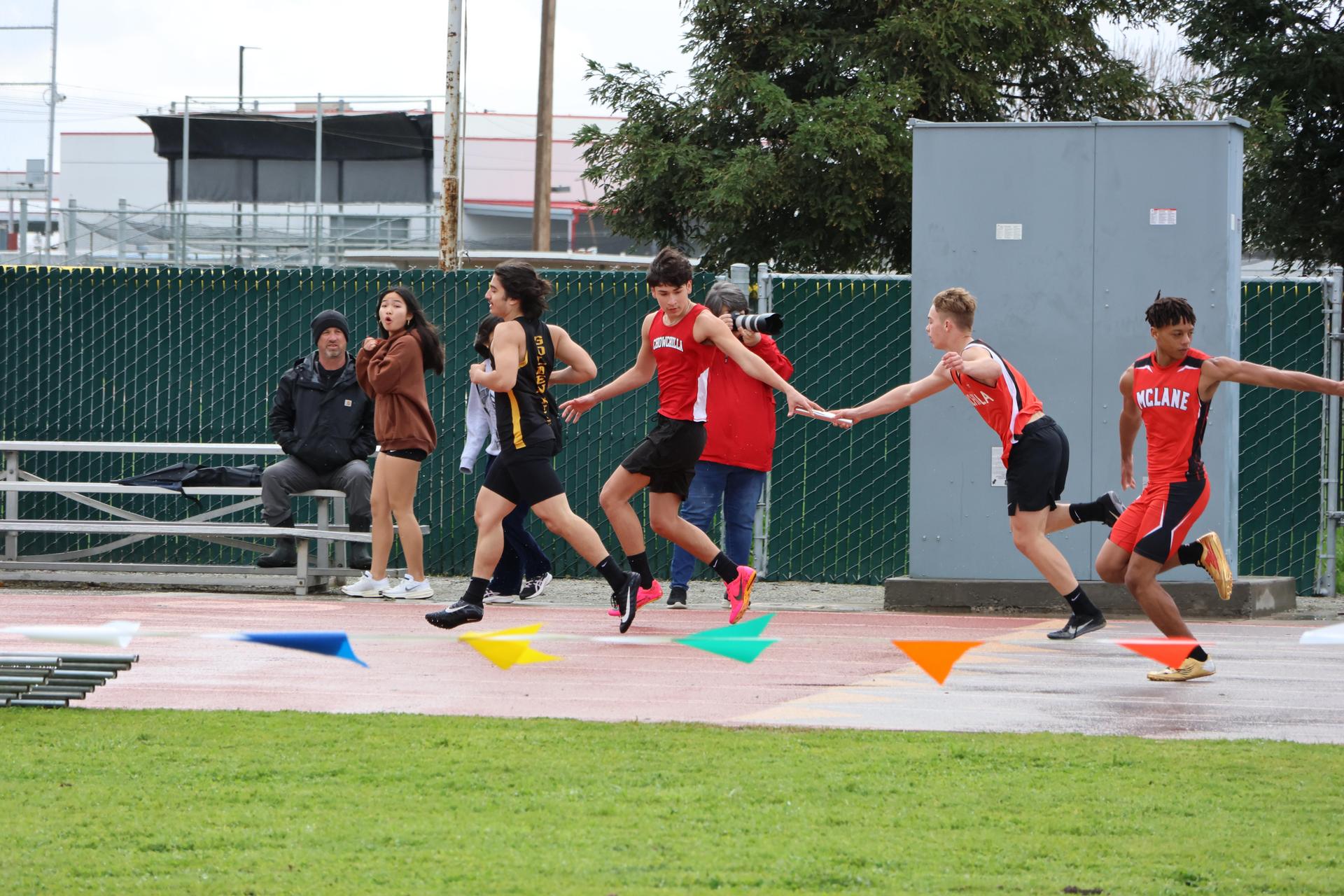 junior varsity boys running the four by 100 meter relay