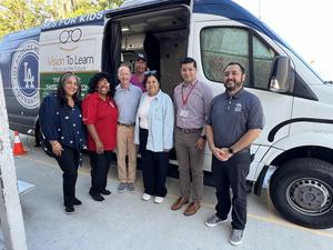 Staff and founder in front of van