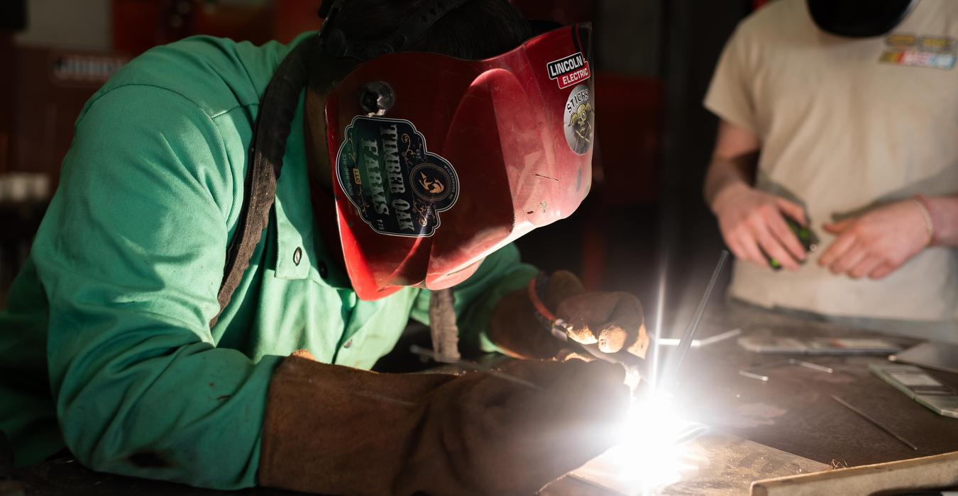 Student working with welding equipment.