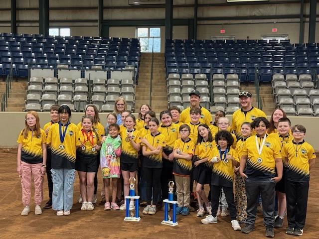Archery team holding trophy