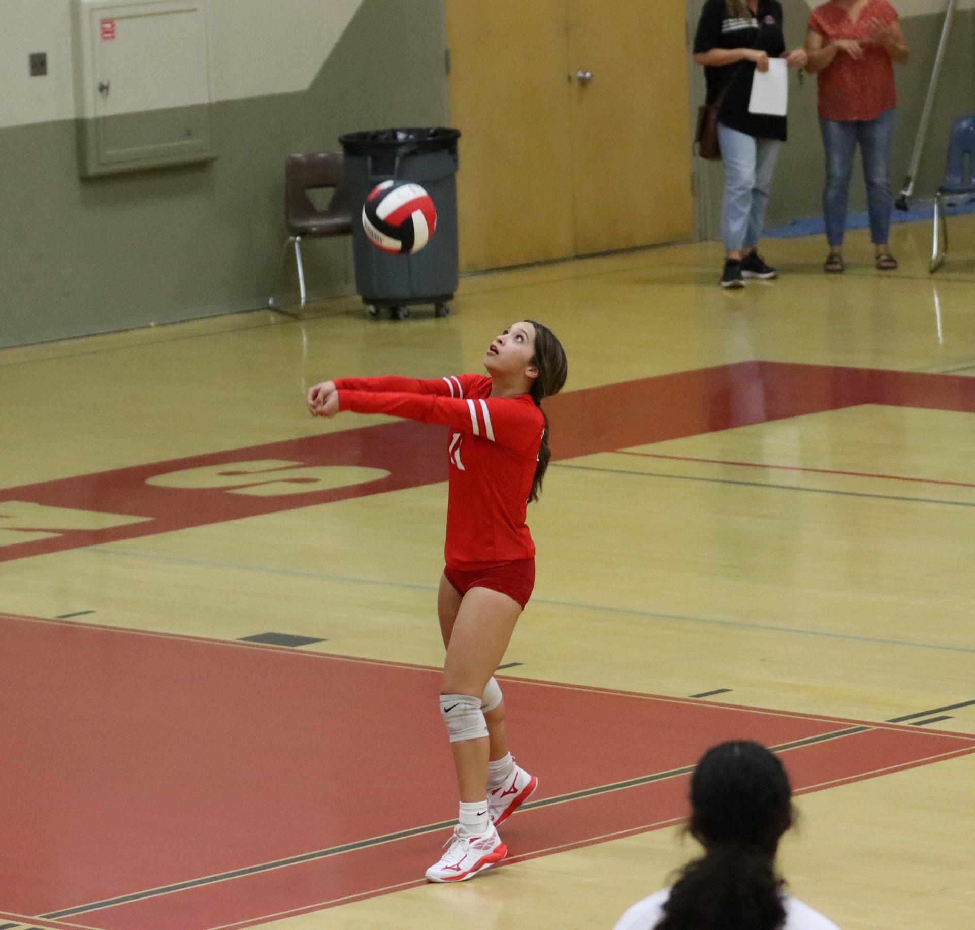 varsity volleyball players in action against liberty