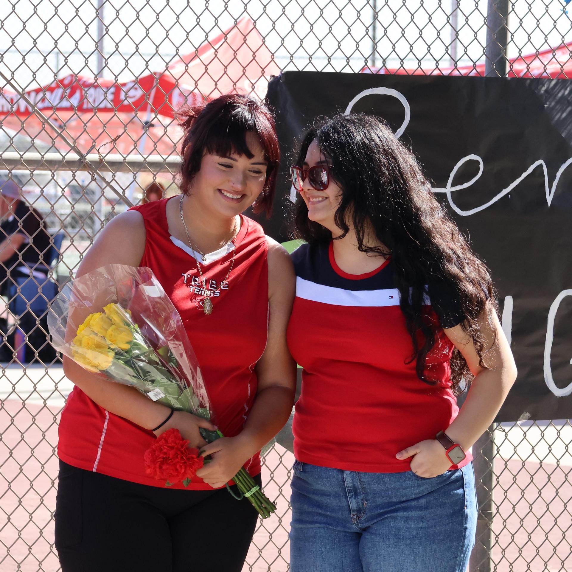 tennis players, family, and staff celebrating senior night