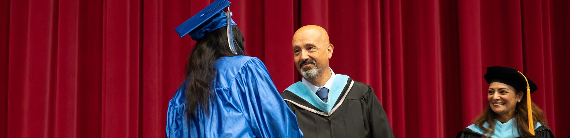 Graduate shaking hand of Superintendent