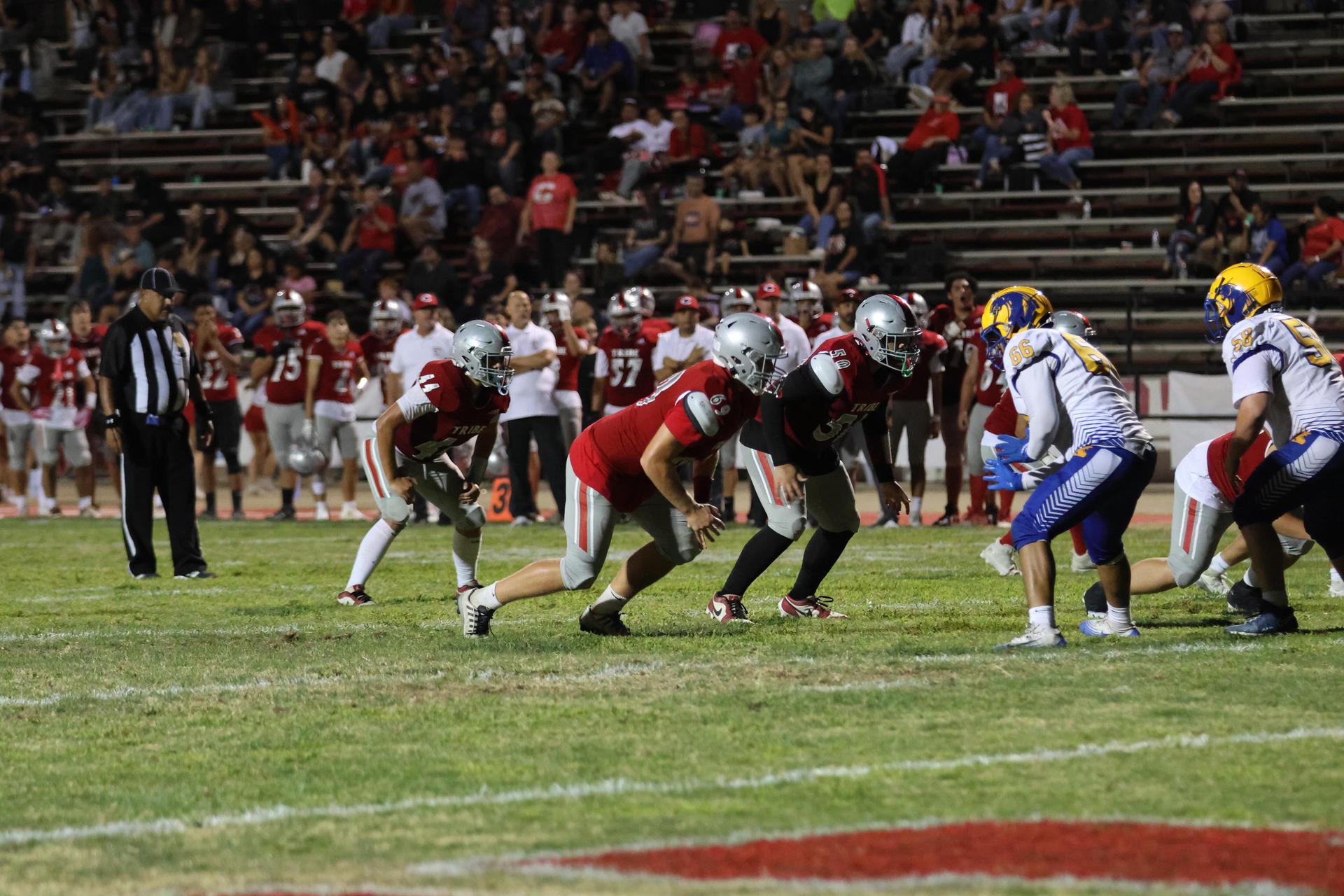Varsity football players in action against Parlier 128