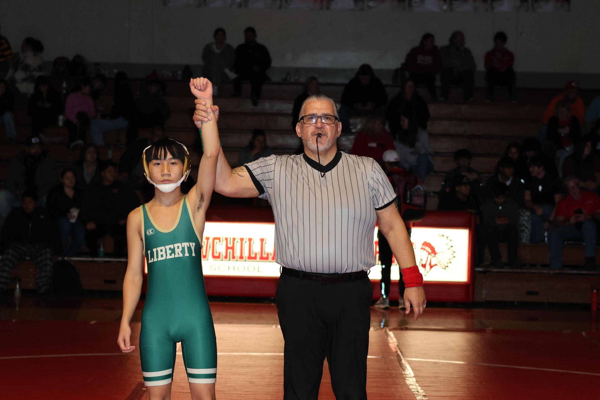 Wrestling winners with hands up 56