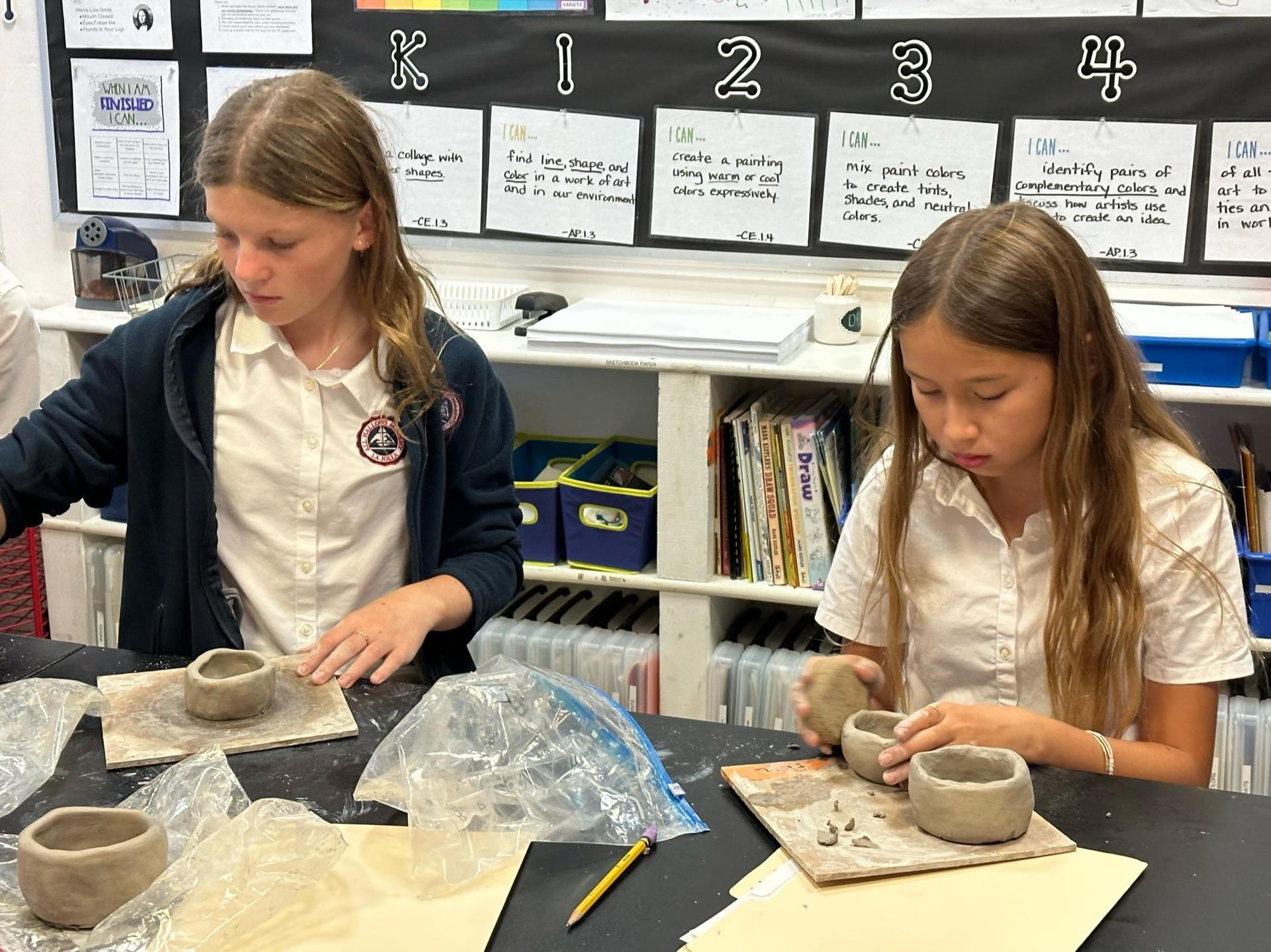  students working in ceramics class