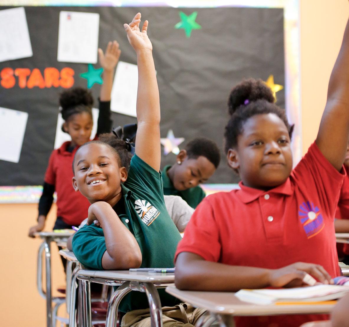 Student working on a notebook in a classroom.