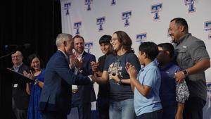 Jessica Cuellar shakes hands with Region 12's Dr. Kenny Berry