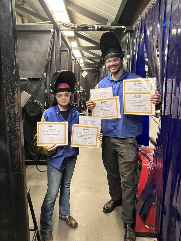 CTI Welding students holding up their program certificates
