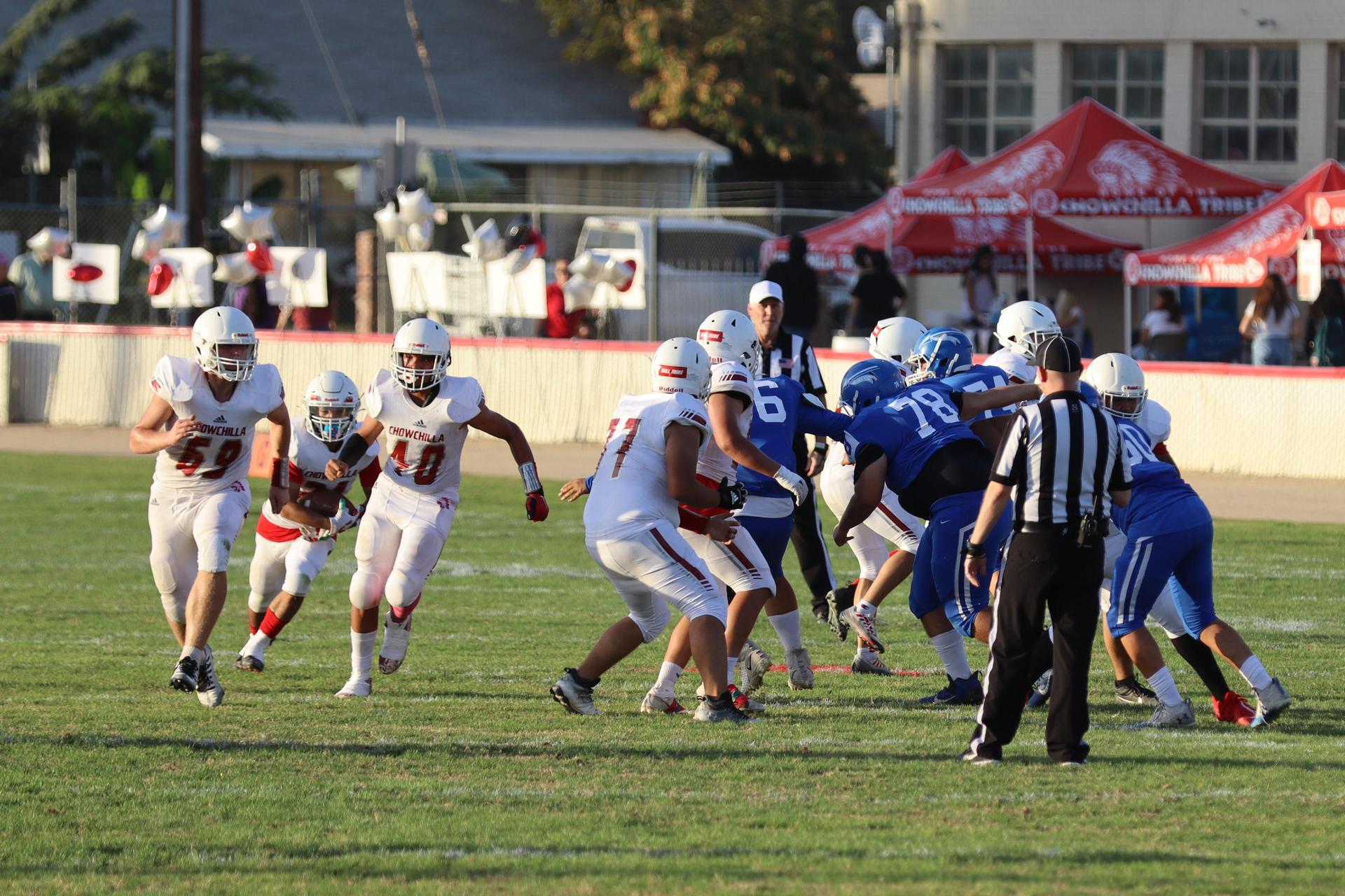 Junior Varsity football players in action against Caruthers