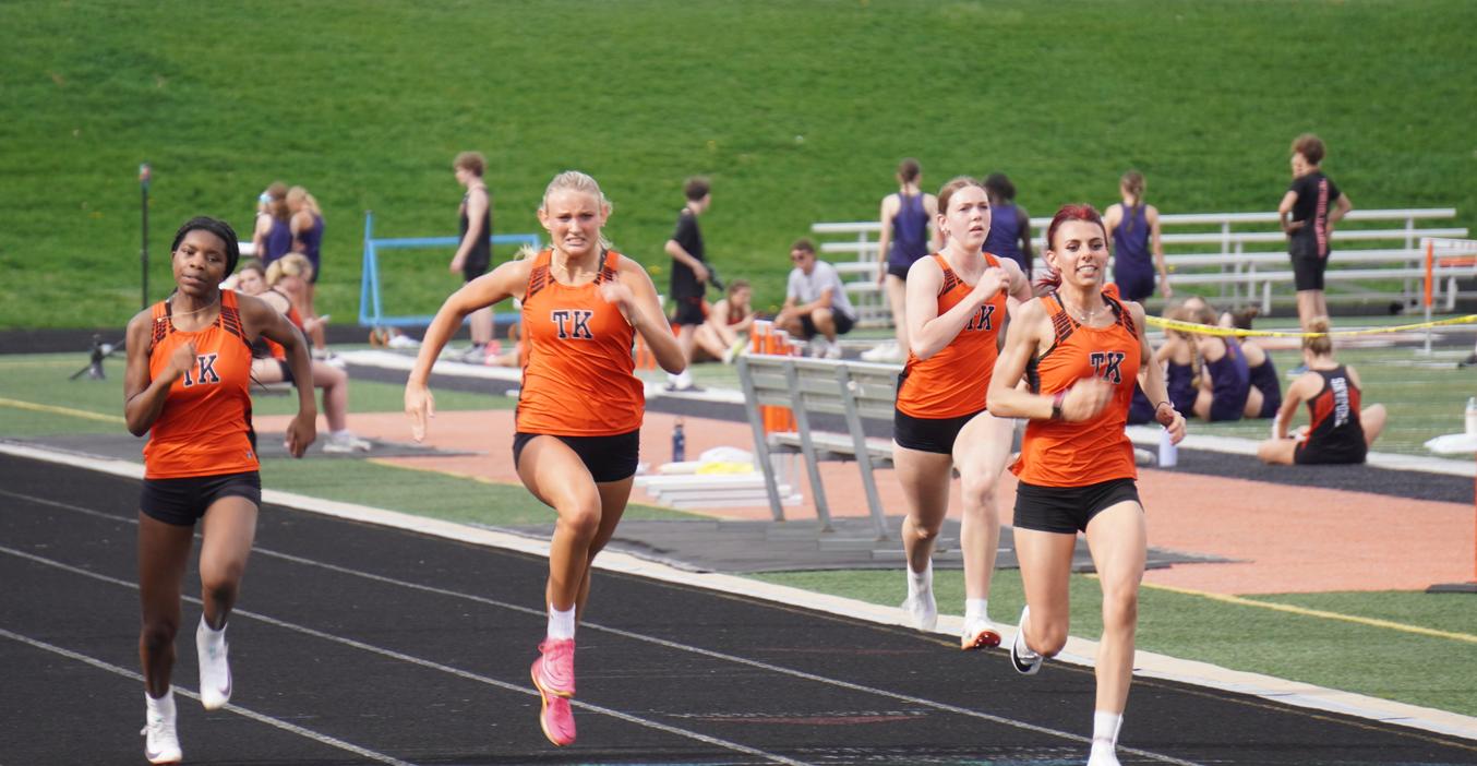 Four TK runners race to the finish line.