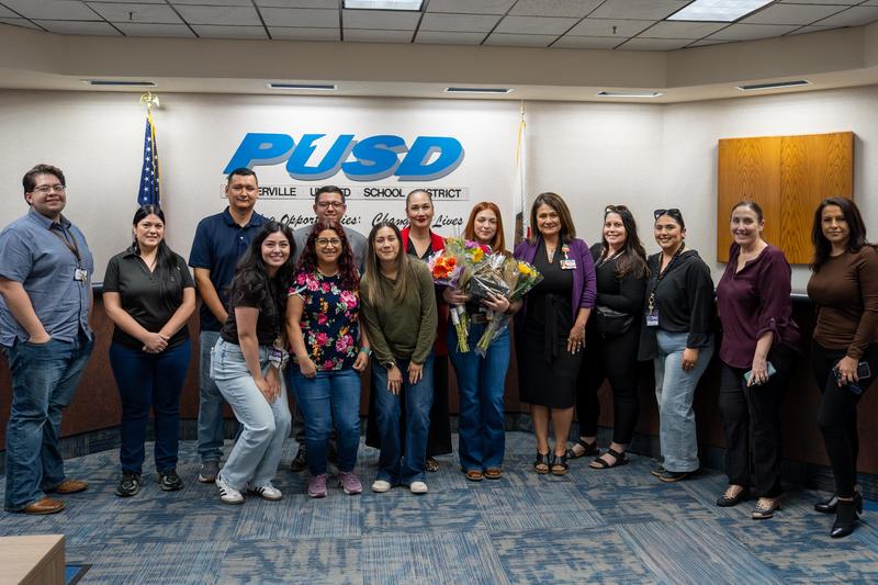 people posing in the governing board room