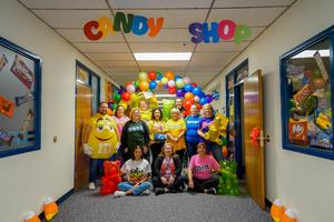 business office staff pose in candy costumes