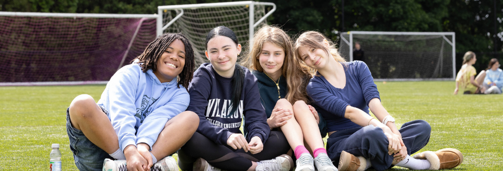 Students having fun during community time on a turf field.