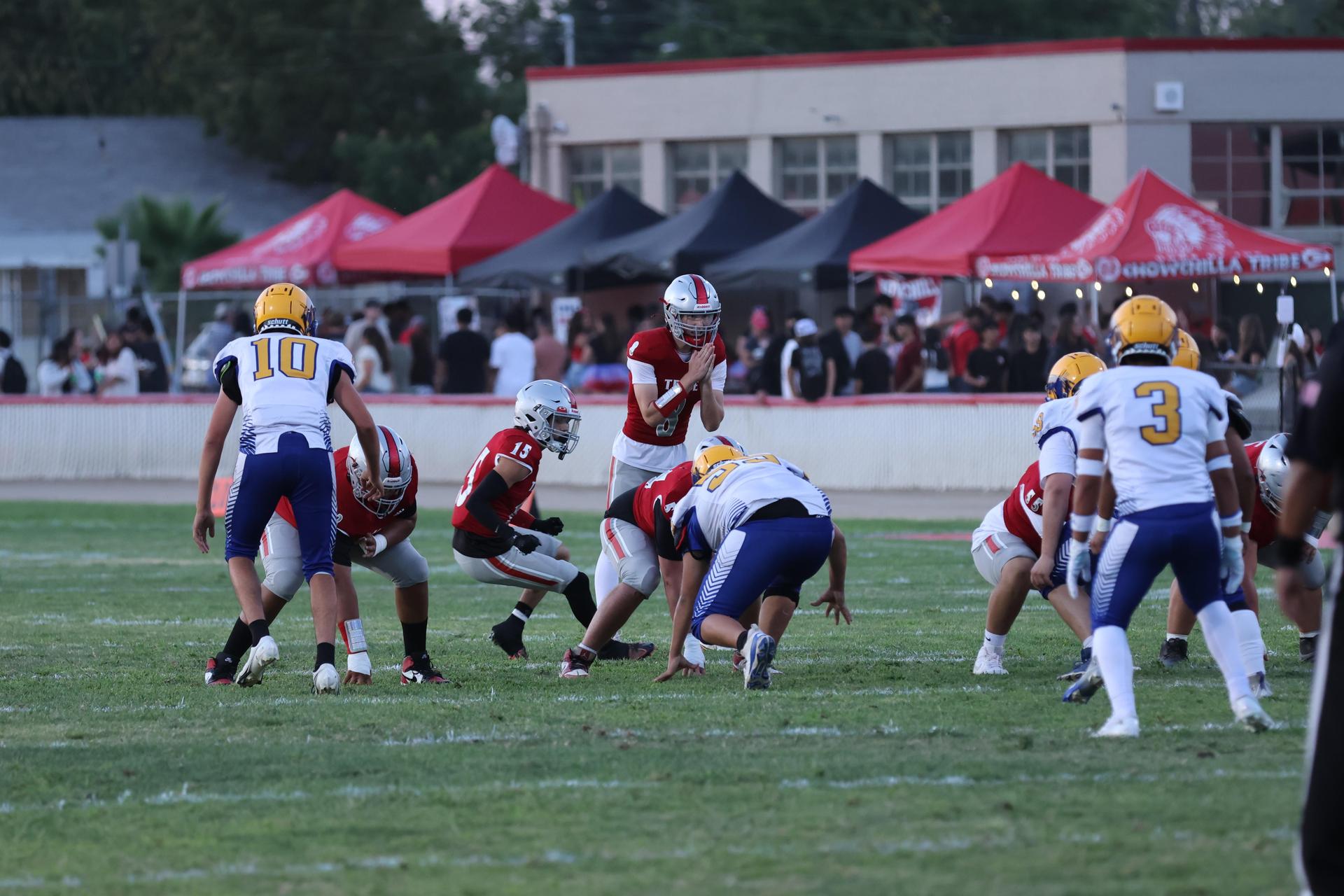 Varsity football players in action against Parlier 3