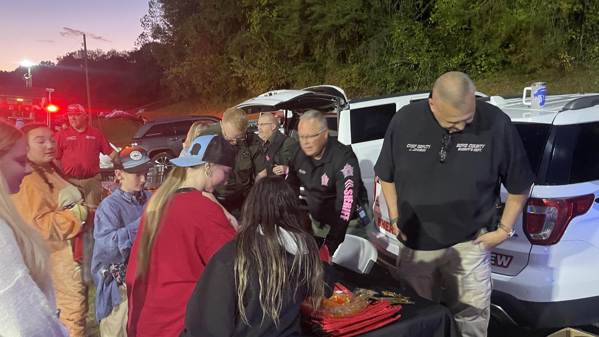 Crowd interacting with law enforcement at a community event.