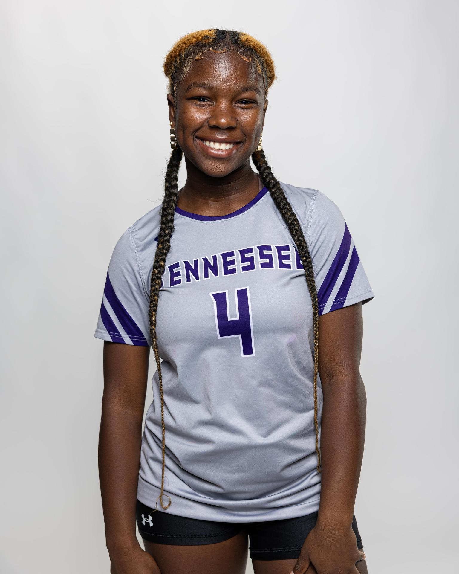 number 4 female volleyball player posing