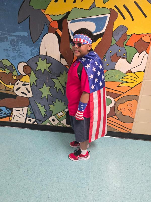 Student wearing an American flag as a cape