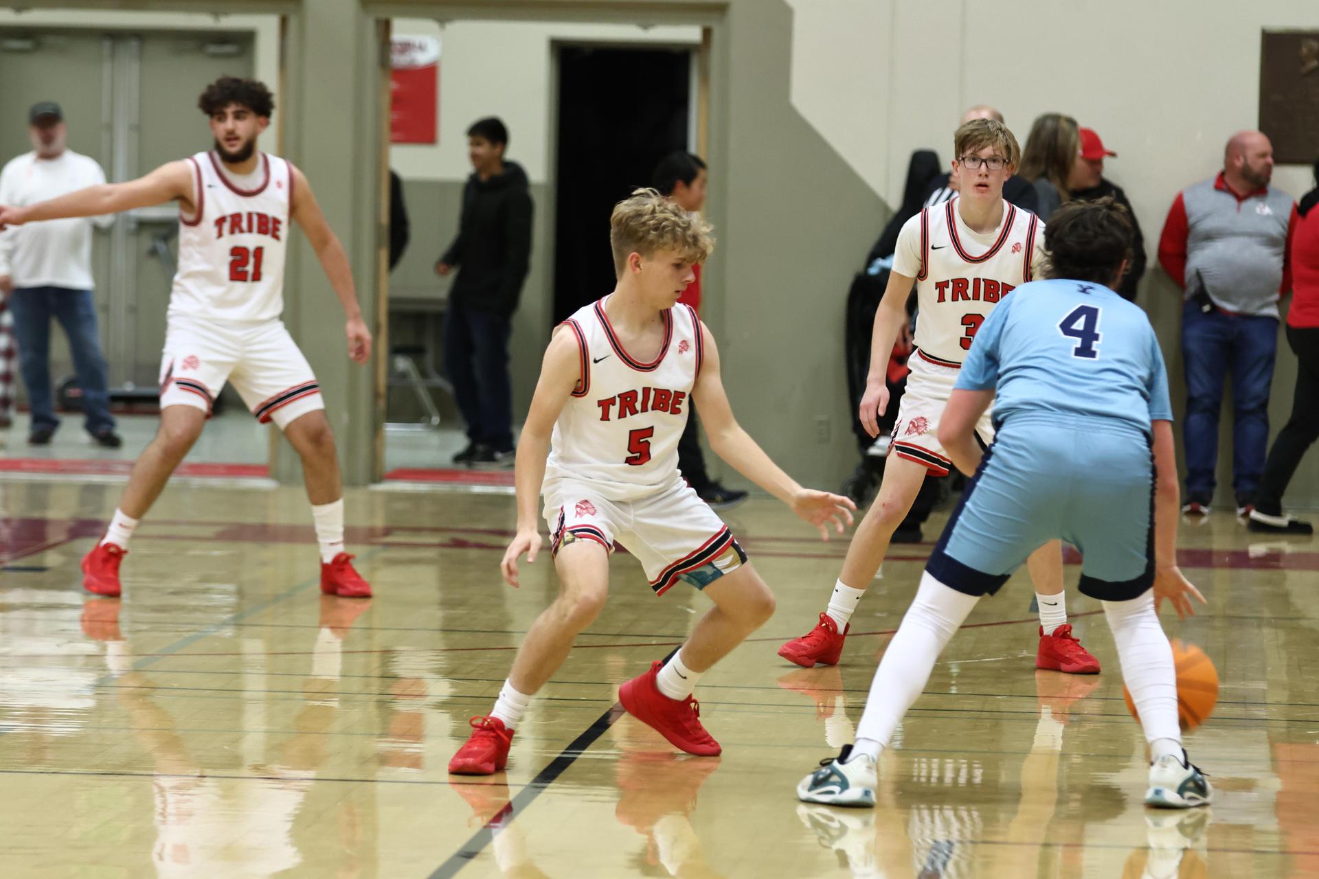 Varsity boys playing basketball against yosemite