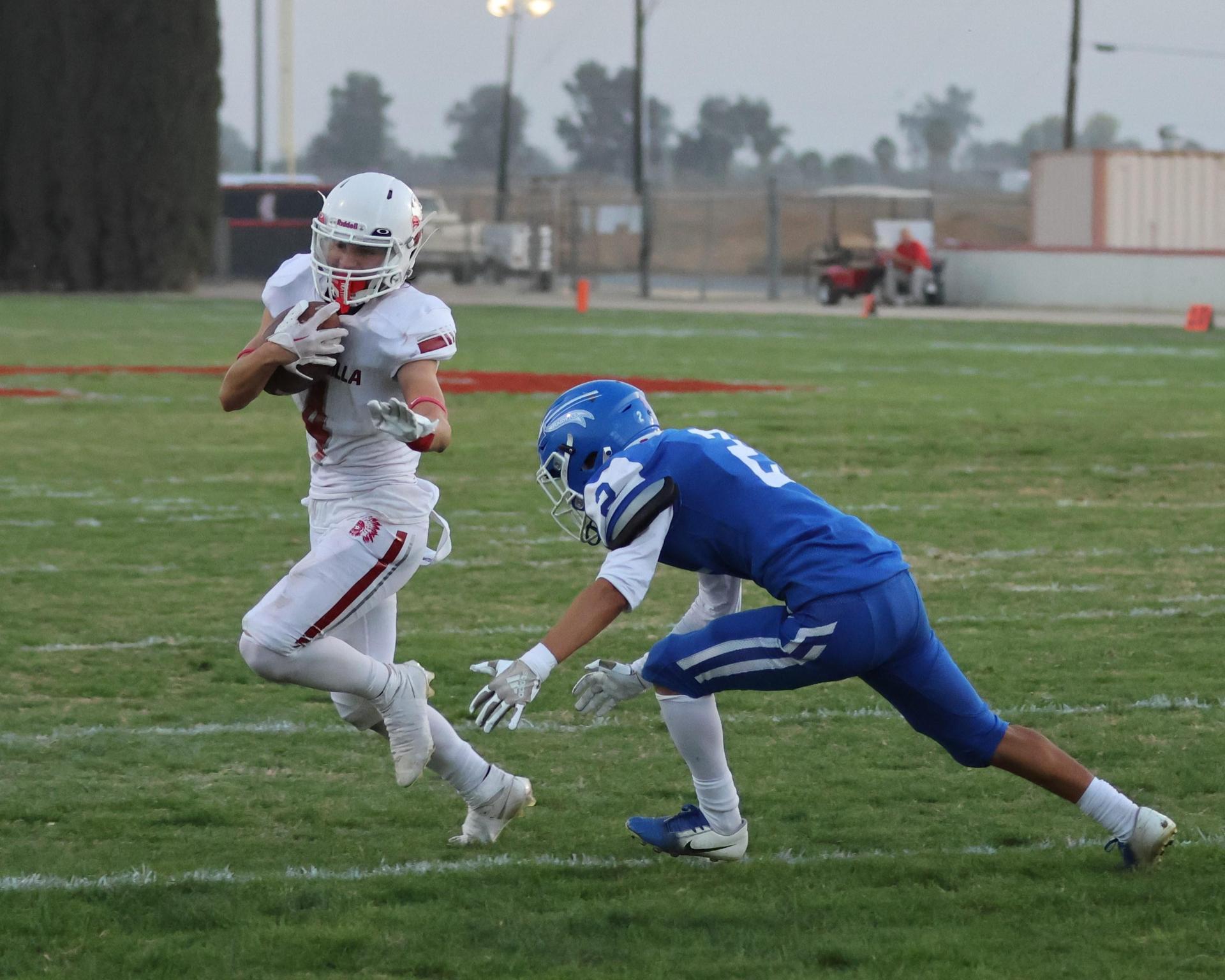 Junior Varsity football players in action against Caruthers