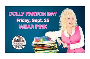 a woman in pink and white leaning on a pile of books