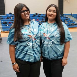 two students in matching YES symposium t-shirts