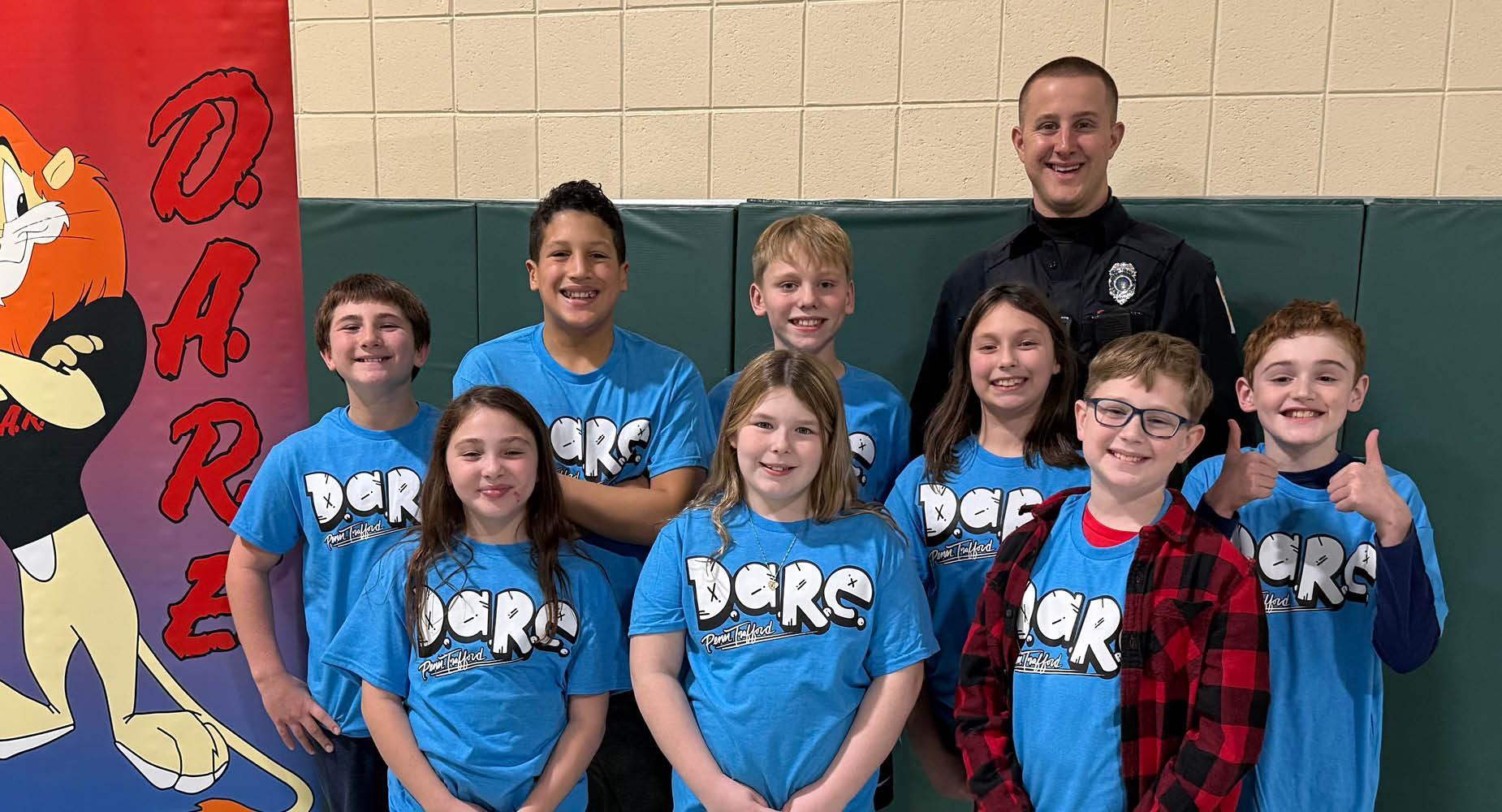 5th graders from Trafford Elementary pose with Officer Meyers when celebrating the completion of the DARE program