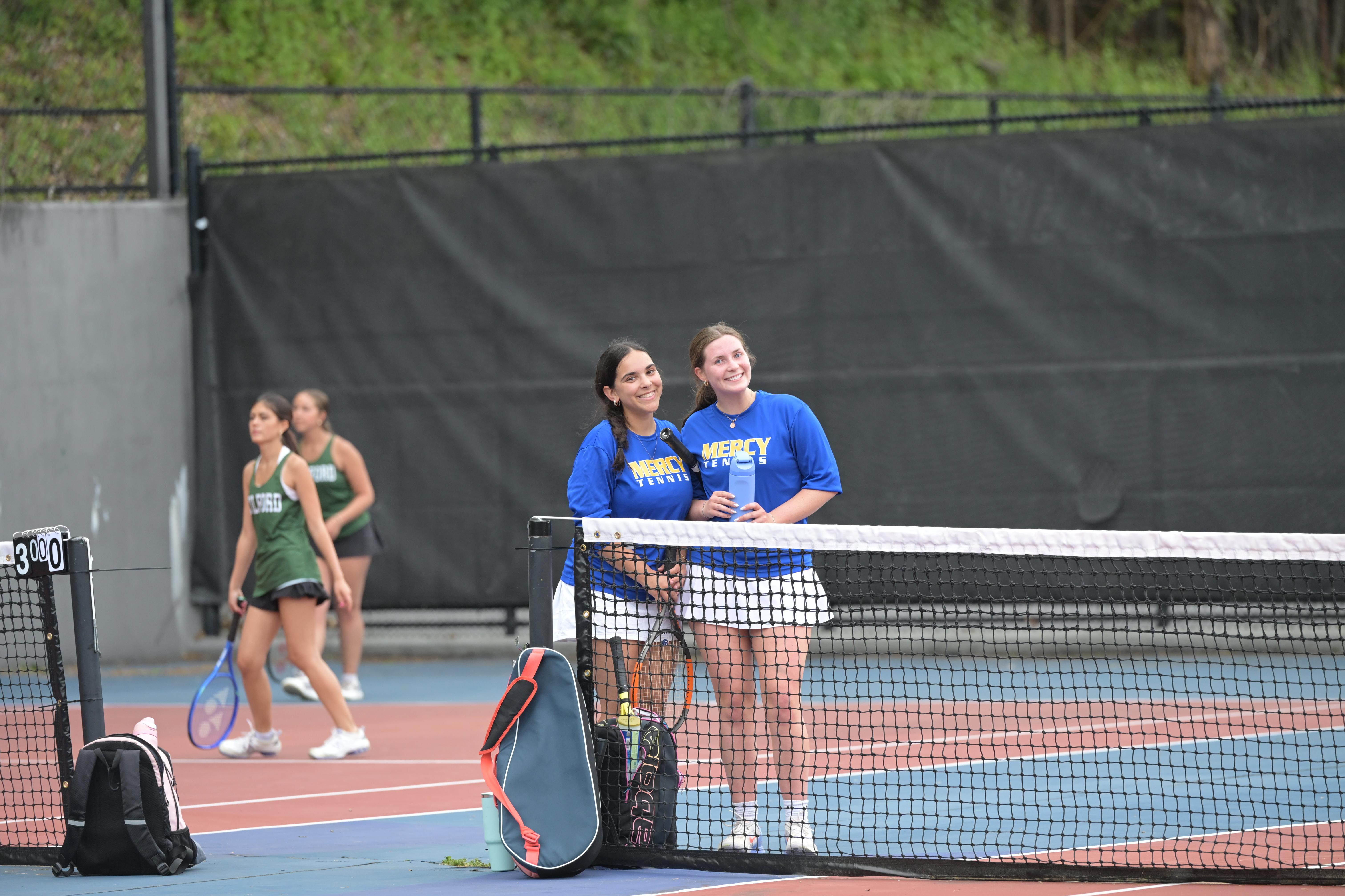 Tennis Players Enjoying A Match Together