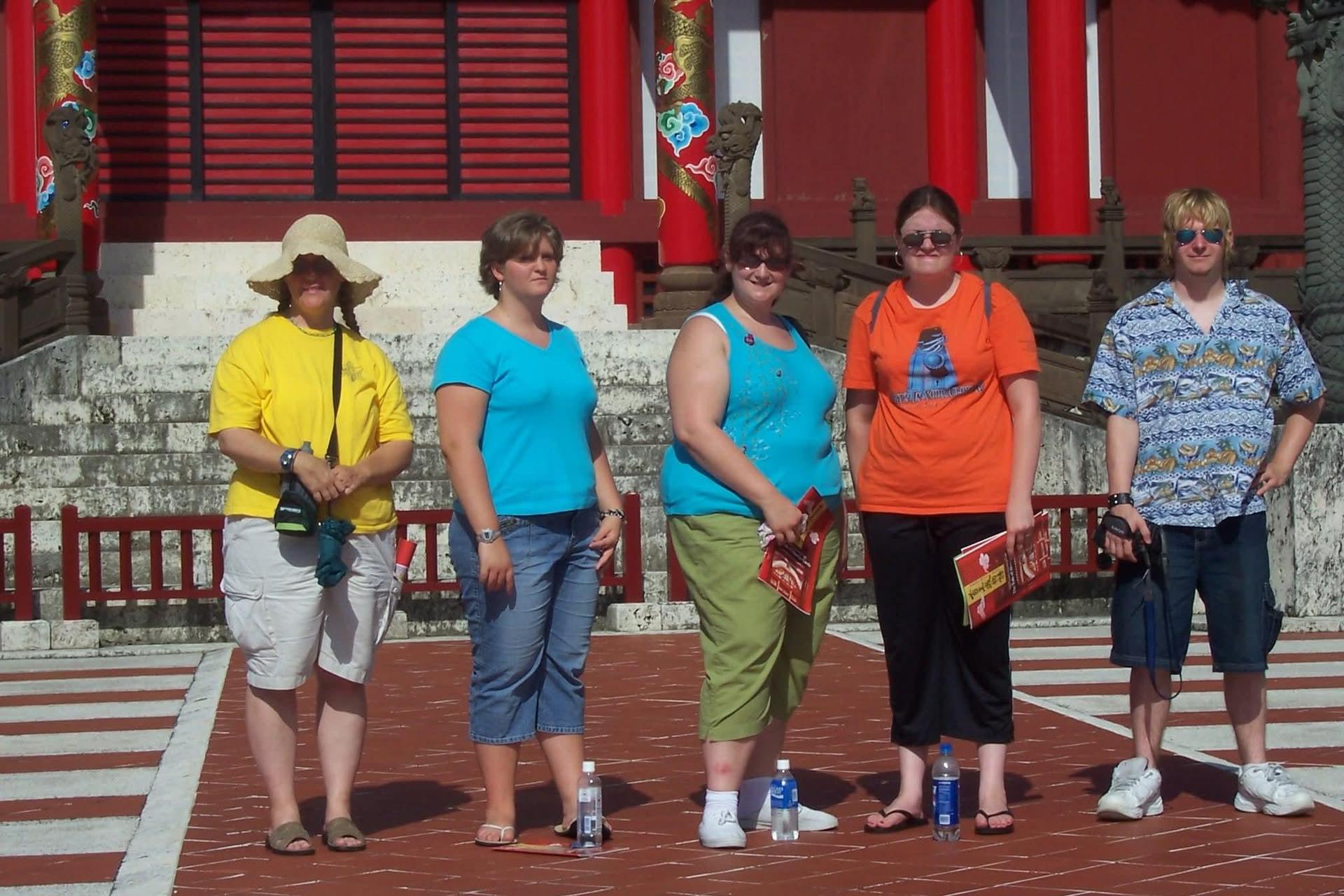 In Japan in front of Shuri Castle. I am in Orange. The Lady in yellow is my mama, the boy in blue is my brother. The other two girls are friends that went with use on the trip.