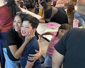 Teacher hugging student