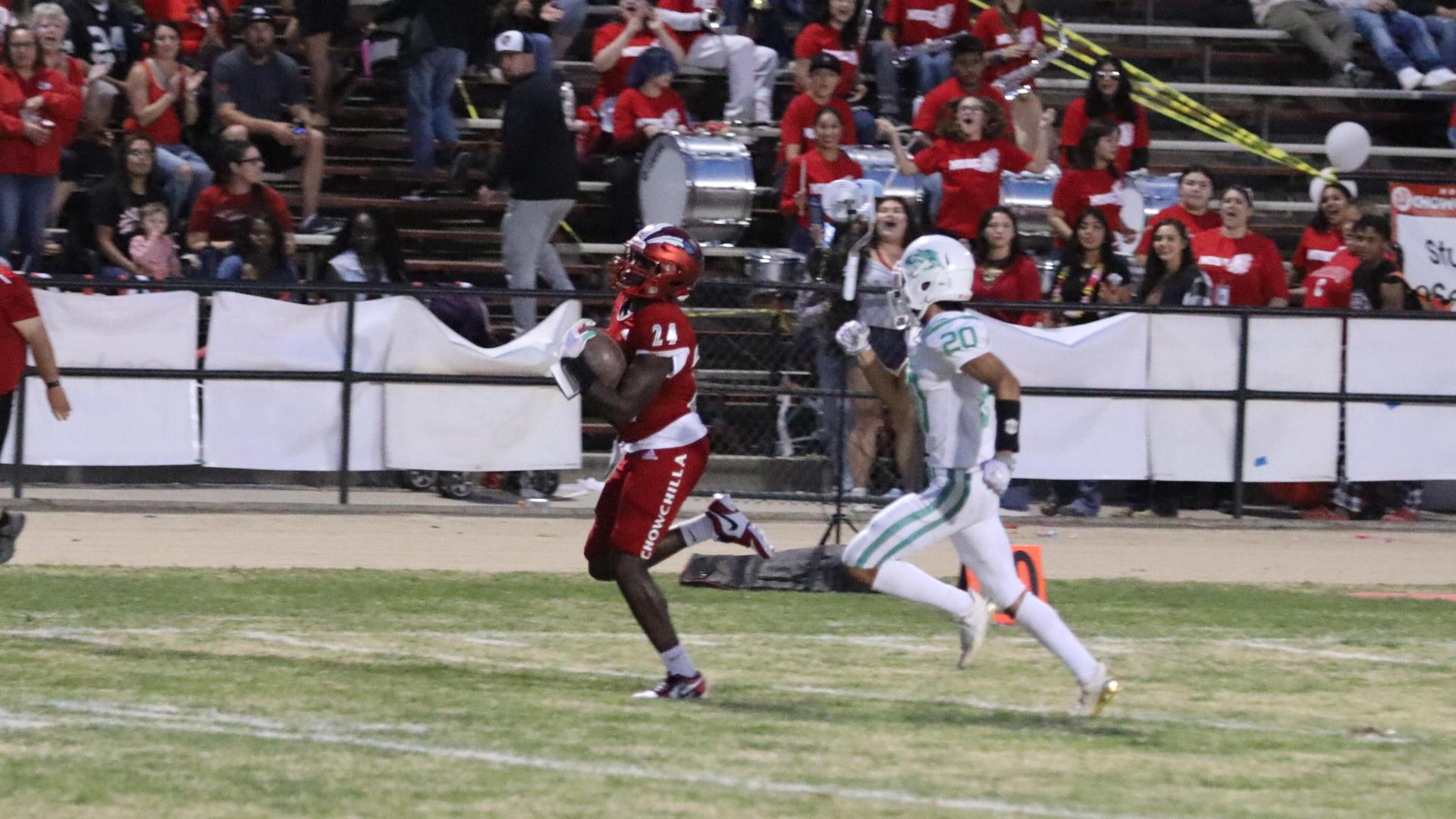 varsity football players in action against Riverdale