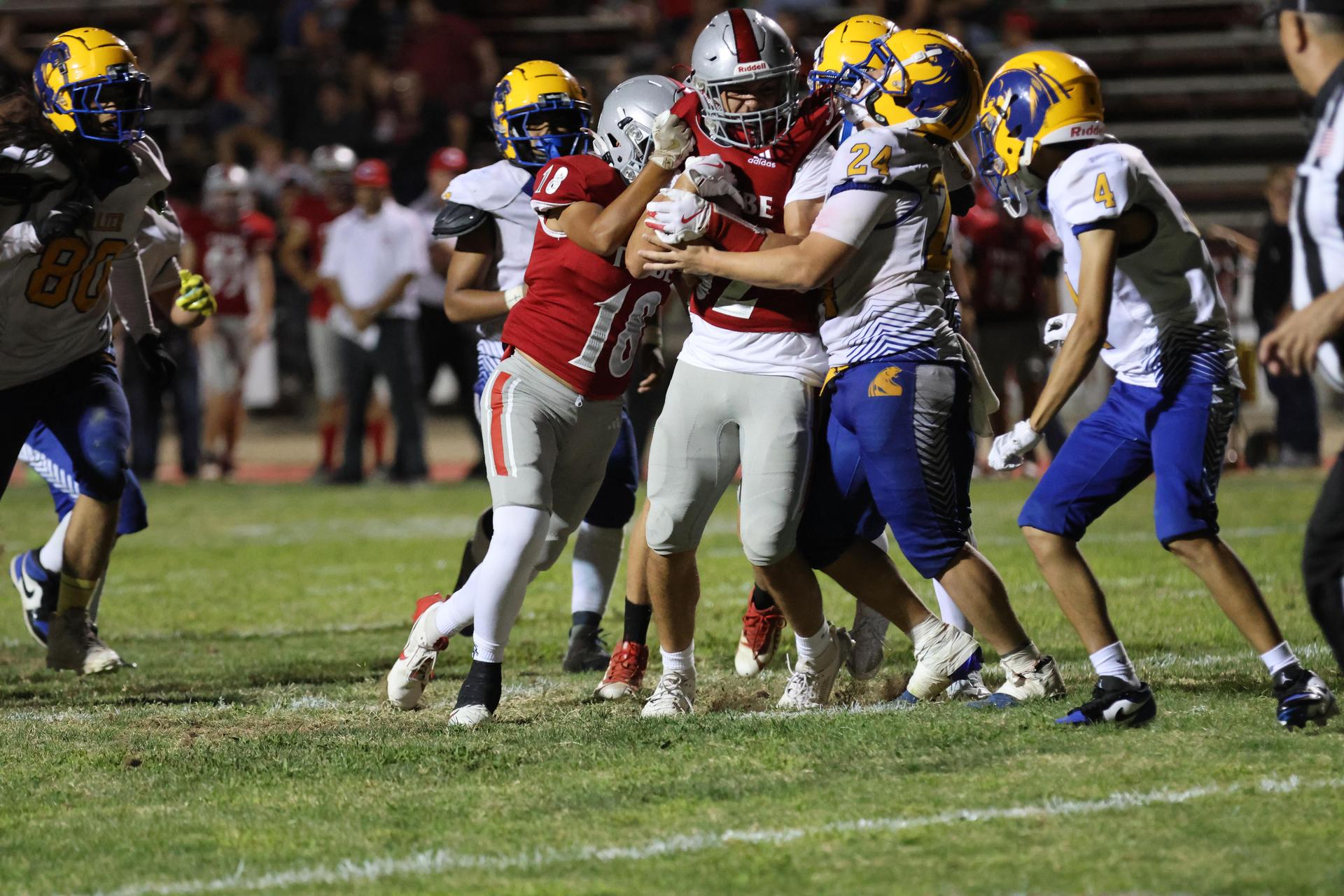 Varsity football players in action against Parlier 116