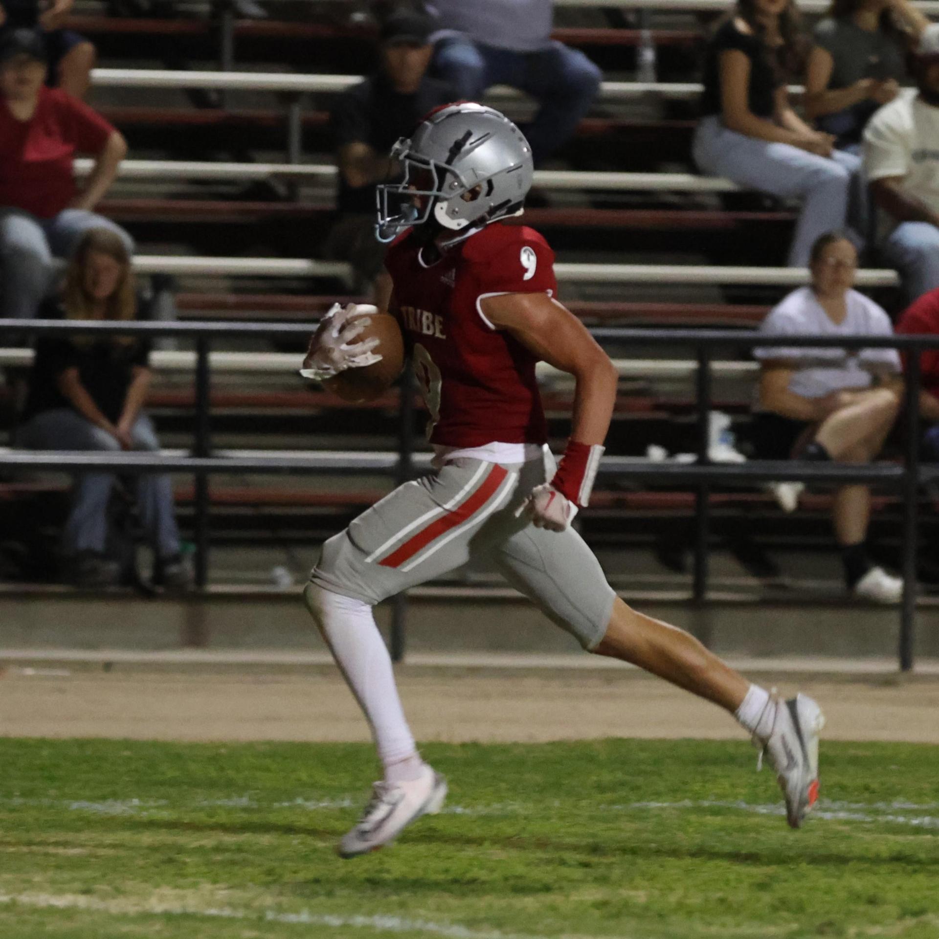 Varsity football players in action against Parlier 27