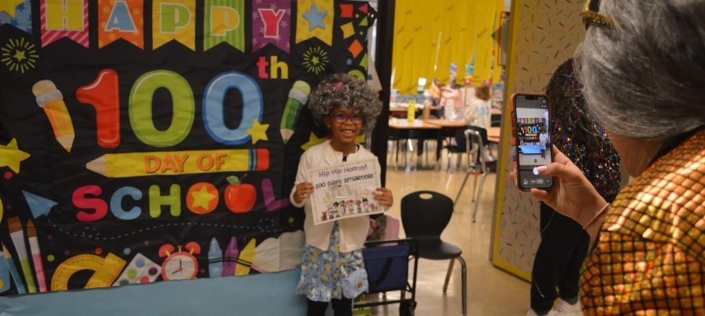 student dressed as senior citizen poses for the camera
